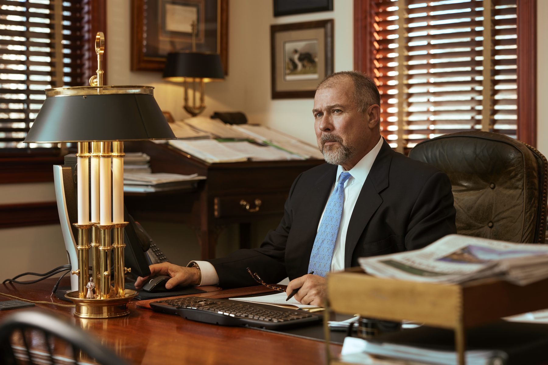 John B. Woodard, Jr., the firm's founder, at his desk researching individual companies